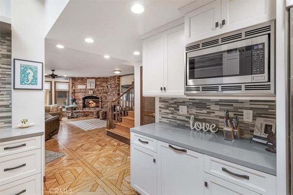 Fireplace, Interior, Kitchen, Living room, Recessed Lighting, Stainless Steel Appliances, Stone Walls, Wood Texture Flooring