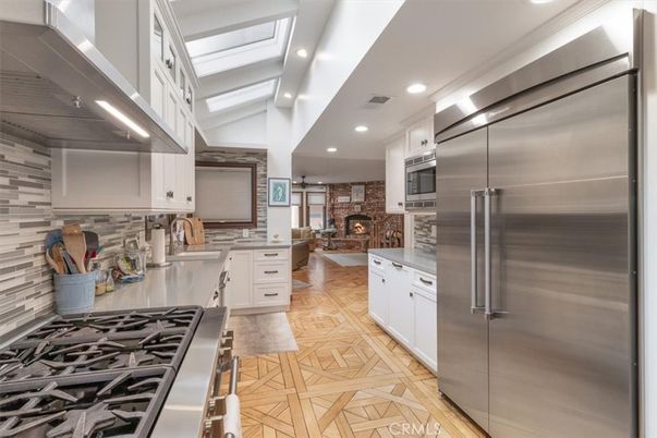 Dining room, Fireplace, Interior, Kitchen, Living room, Pendant Lights, Recessed Lighting, Stainless Steel Appliances, Stone Walls, Wood Texture Flooring