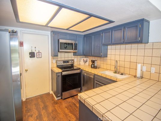 Interior, Kitchen, Stainless Steel Appliances, Tile Countertops, Wood Texture Flooring