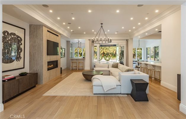 Chandelier, Fireplace, Interior, Living room, Pendant Lights, Recessed Lighting, Wood Texture Flooring