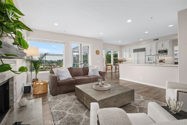 Dining room, Fireplace, Interior, Kitchen, Living room, Recessed Lighting, Stainless Steel Appliances, Wood Texture Flooring