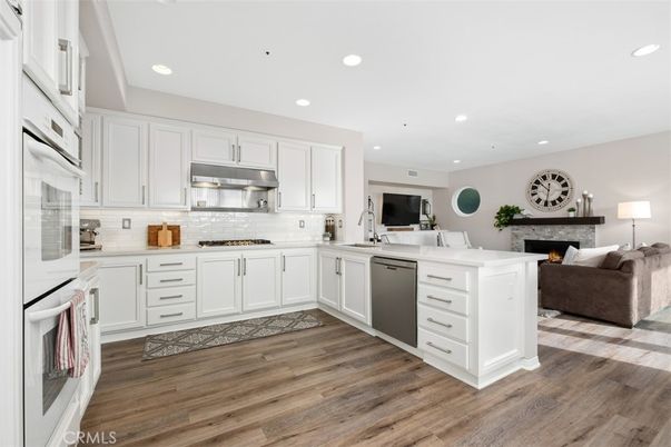 Fireplace, Interior, Kitchen, Living room, Recessed Lighting, Stainless Steel Appliances, Wood Texture Flooring