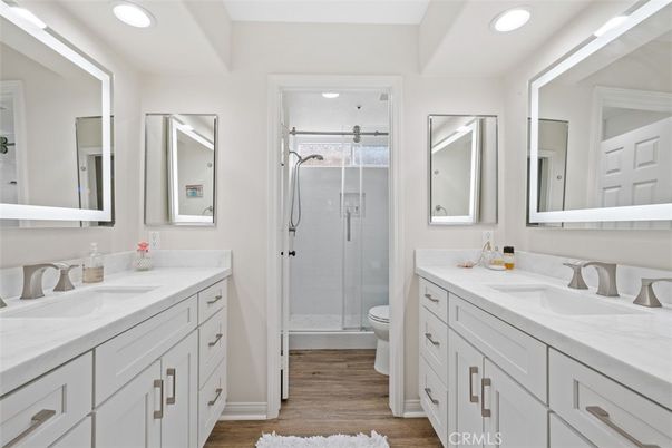 Bathroom, Dual Sink Vanities, Glass Shower, Interior, Recessed Lighting, Wood Texture Flooring