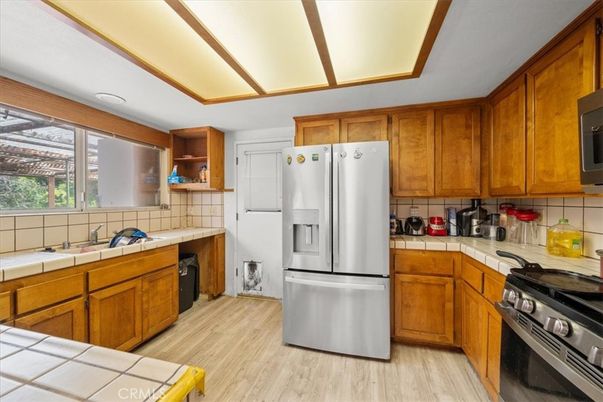 Interior, Kitchen, Stainless Steel Appliances, Tile Countertops, Wood Texture Flooring