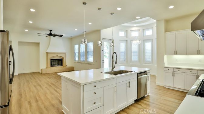 Chandelier, Fireplace, Interior, Kitchen, Pendant Lights, Recessed Lighting, Stainless Steel Appliances, Wood Texture Flooring