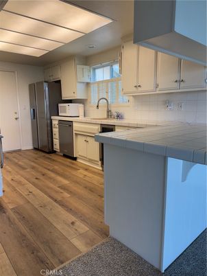 Interior, Kitchen, Stainless Steel Appliances, Tile Countertops, Wood Texture Flooring