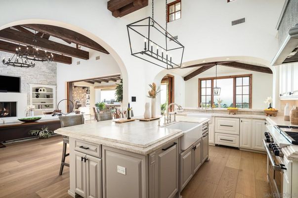 Chandelier, Fireplace, Interior, Kitchen, Pendant Lights, Stainless Steel Appliances, Stone Walls, Wooden Beams, Wood Texture Flooring