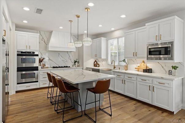 Interior, Kitchen, Marble Walls, Pendant Lights, Recessed Lighting, Stainless Steel Appliances, Wood Texture Flooring