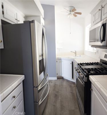 Interior, Kitchen, Stainless Steel Appliances, Tile Countertops, Wood Texture Flooring
