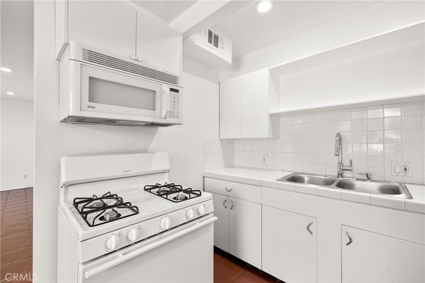Interior, Kitchen, Recessed Lighting, Tile Countertops, Wood Texture Flooring