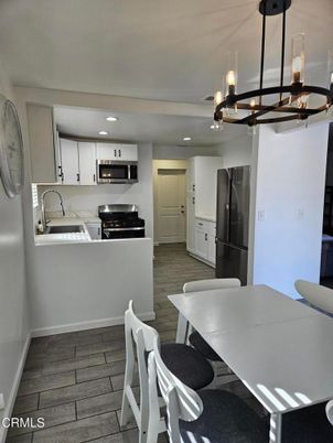 Dining room, Interior, Kitchen, Pendant Lights, Recessed Lighting, Stainless Steel Appliances, Wood Texture Flooring
