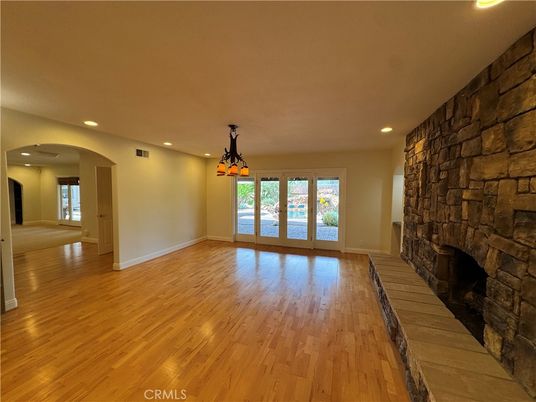 Empty room, Fireplace, Interior, Pendant Lights, Recessed Lighting, Stone Walls, Wood Texture Flooring