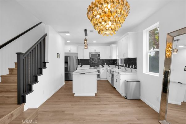 Chandelier, Interior, Kitchen, Pendant Lights, Recessed Lighting, Stainless Steel Appliances, Wood Texture Flooring