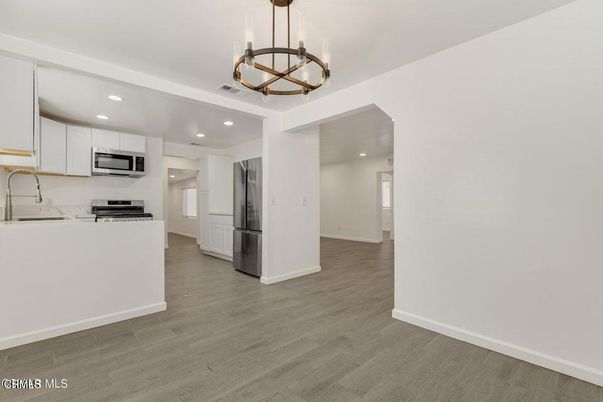 Chandelier, Interior, Kitchen, Pendant Lights, Recessed Lighting, Stainless Steel Appliances, Wood Texture Flooring