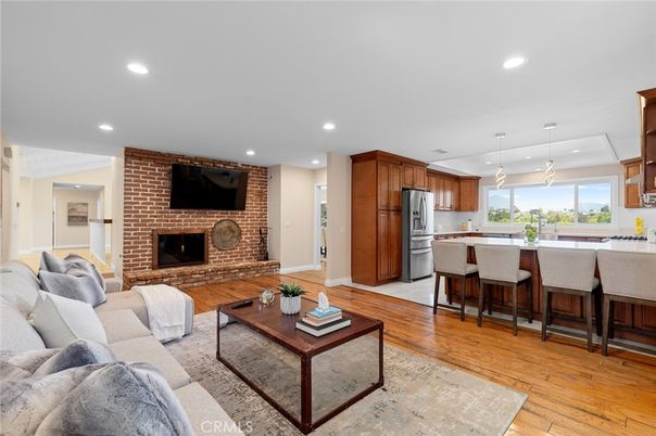Fireplace, Interior, Kitchen, Living room, Pendant Lights, Recessed Lighting, Stainless Steel Appliances, Stone Walls, Wood Texture Flooring