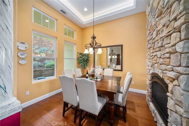 Chandelier, Dining room, Fireplace, Interior, Recessed Lighting, Stone Walls, Wood Texture Flooring