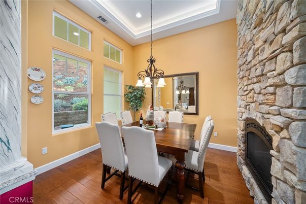 Chandelier, Dining room, Fireplace, Interior, Recessed Lighting, Stone Walls, Wood Texture Flooring