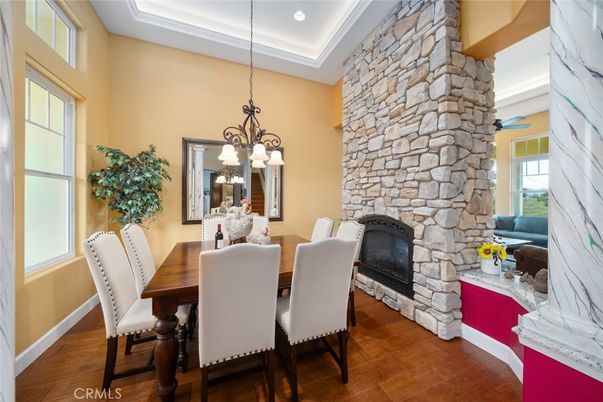 Chandelier, Dining room, Fireplace, Interior, Pendant Lights, Recessed Lighting, Stone Walls, Wood Texture Flooring