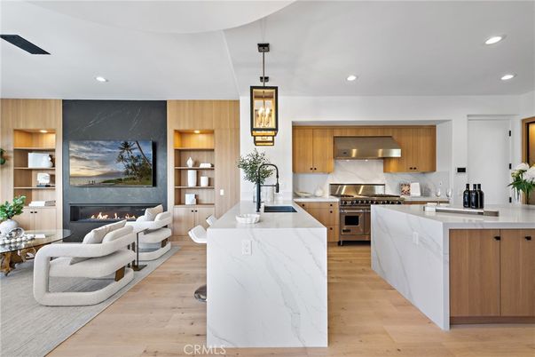 Fireplace, Interior, Kitchen, Living room, Marble Walls, Pendant Lights, Recessed Lighting, Stainless Steel Appliances, Wood Texture Flooring