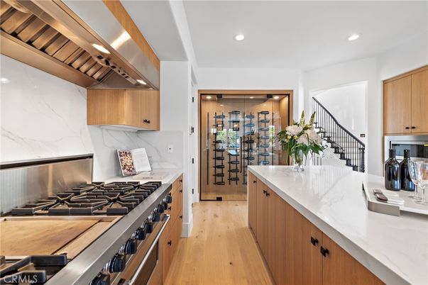 Interior, Kitchen, Marble Walls, Recessed Lighting, Stainless Steel Appliances, Wine Storage, Wood Texture Flooring