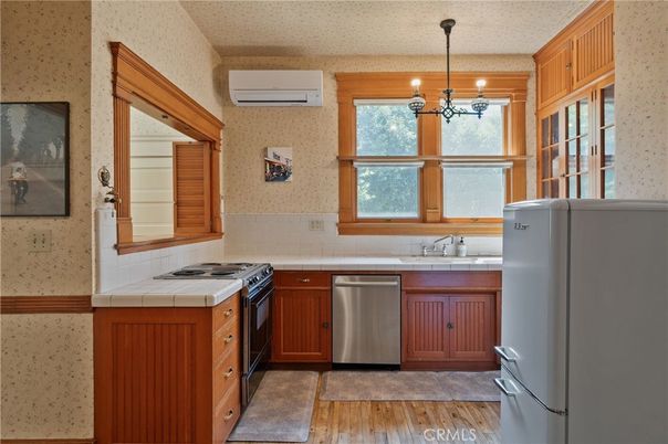 Interior, Kitchen, Pendant Lights, Stainless Steel Appliances, Tile Countertops, Wood Texture Flooring