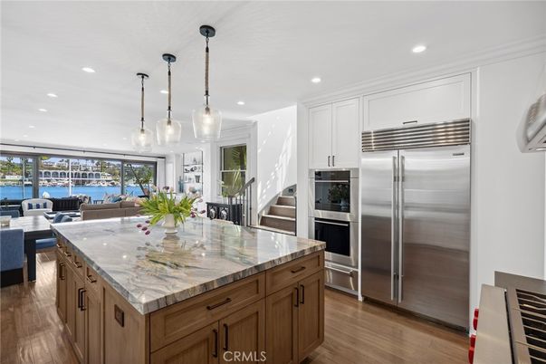 Dining room, Interior, Kitchen, Living room, Pendant Lights, Recessed Lighting, Stainless Steel Appliances, Water, Wood Texture Flooring