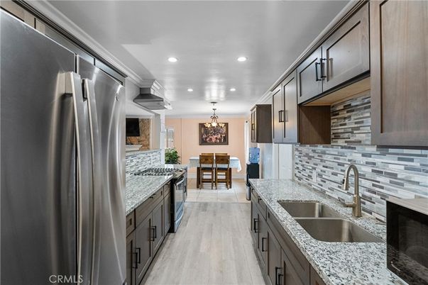 Chandelier, Dining room, Interior, Kitchen, Recessed Lighting, Stainless Steel Appliances, Wood Texture Flooring
