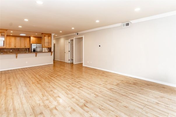Empty room, Interior, Kitchen, Recessed Lighting, Stainless Steel Appliances, Wood Texture Flooring