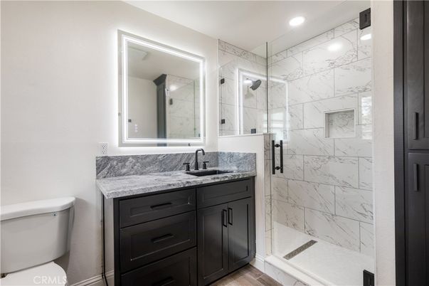 Bathroom, Glass Shower, Interior, Marble Walls, Recessed Lighting, Wood Texture Flooring