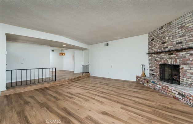Empty room, Fireplace, Interior, Recessed Lighting, Stone Walls, Wood Texture Flooring