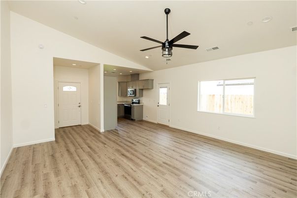 Empty room, Interior, Kitchen, Recessed Lighting, Stainless Steel Appliances, Wood Texture Flooring