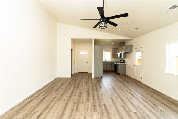 Empty room, Interior, Kitchen, Recessed Lighting, Stainless Steel Appliances, Wood Texture Flooring