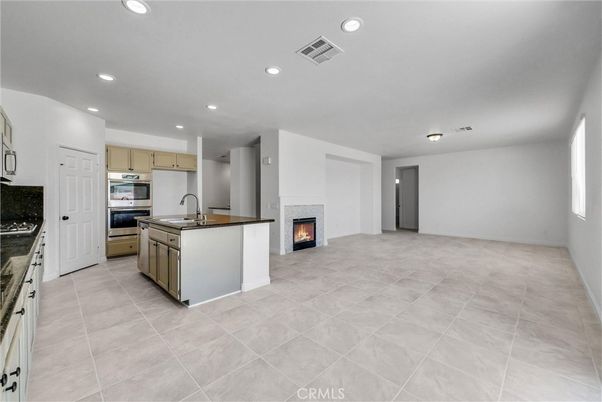 Empty room, Fireplace, Interior, Kitchen, Recessed Lighting, Stainless Steel Appliances
