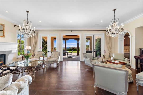 Chandelier, Fireplace, Interior, Living room, Piano, Recessed Lighting, Wood Texture Flooring