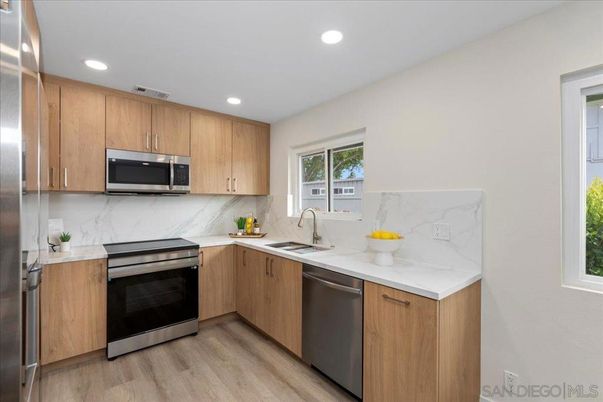 Interior, Kitchen, Marble Walls, Recessed Lighting, Stainless Steel Appliances, Wood Texture Flooring