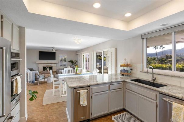 Dining room, Fireplace, Interior, Kitchen, Living room, Recessed Lighting, Stainless Steel Appliances, Wood Texture Flooring