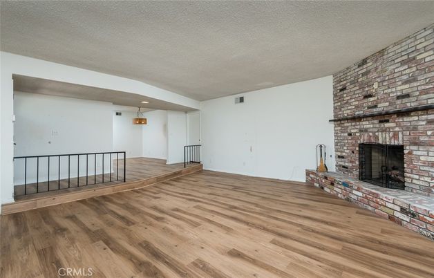 Empty room, Fireplace, Interior, Recessed Lighting, Stone Walls, Wood Texture Flooring