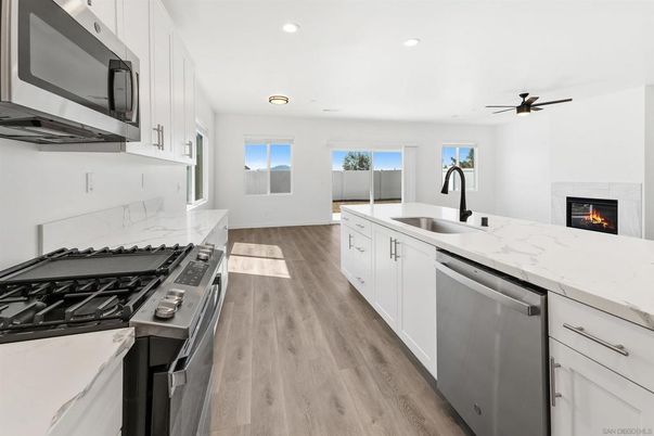 Fireplace, Interior, Kitchen, Recessed Lighting, Stainless Steel Appliances, Wood Texture Flooring