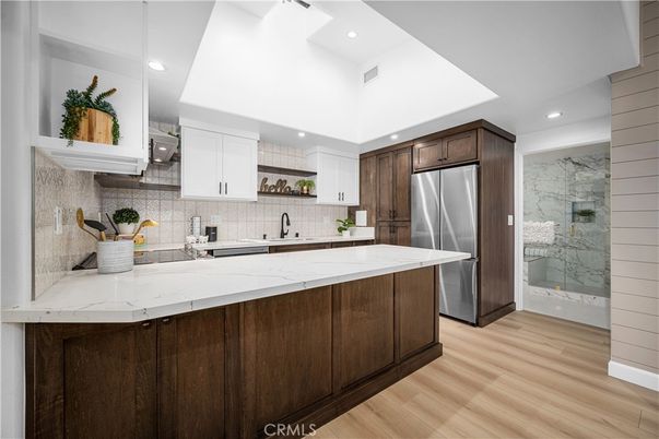 Interior, Kitchen, Marble Walls, Recessed Lighting, Stainless Steel Appliances, Wood Texture Flooring