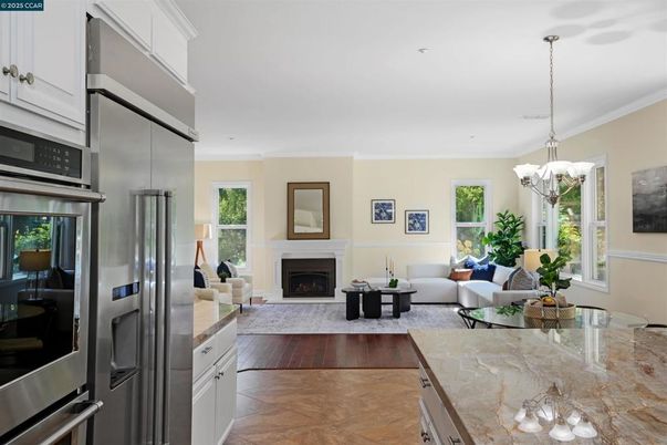 Chandelier, Fireplace, Interior, Kitchen, Living room, Recessed Lighting, Stainless Steel Appliances, Wood Texture Flooring