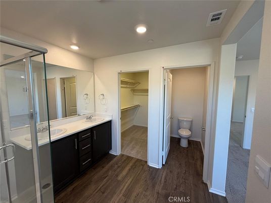 Bathroom, Dual Sink Vanities, Glass Shower, Interior, Recessed Lighting, Walk-in Closets, Wood Texture Flooring