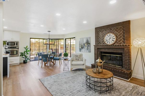 Chandelier, Dining room, Fireplace, Interior, Kitchen, Living room, Pendant Lights, Recessed Lighting, Stainless Steel Appliances, Stone Walls, Wood Texture Flooring