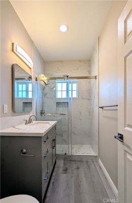 Bathroom, Glass Shower, Interior, Marble Walls, Recessed Lighting, Wood Texture Flooring