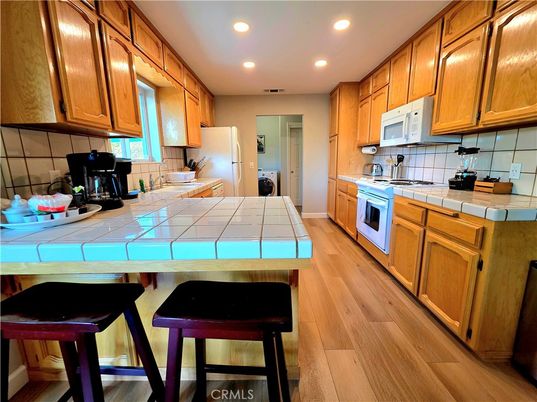 Interior, Kitchen, Recessed Lighting, Tile Countertops, Wood Texture Flooring