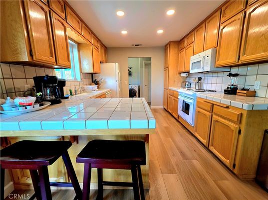Interior, Kitchen, Recessed Lighting, Tile Countertops, Wood Texture Flooring