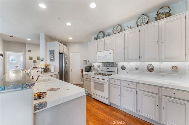 Interior, Kitchen, Recessed Lighting, Tile Countertops, Wood Texture Flooring