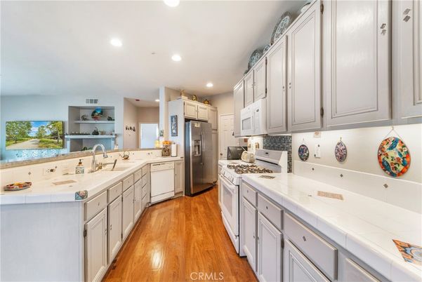 Interior, Kitchen, Recessed Lighting, Tile Countertops, Wood Texture Flooring