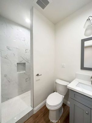 Bathroom, Glass Shower, Interior, Marble Walls, Recessed Lighting, Wood Texture Flooring
