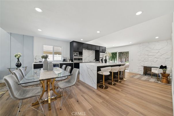 Dining room, Fireplace, Interior, Kitchen, Marble Walls, Recessed Lighting, Stainless Steel Appliances, Wood Texture Flooring