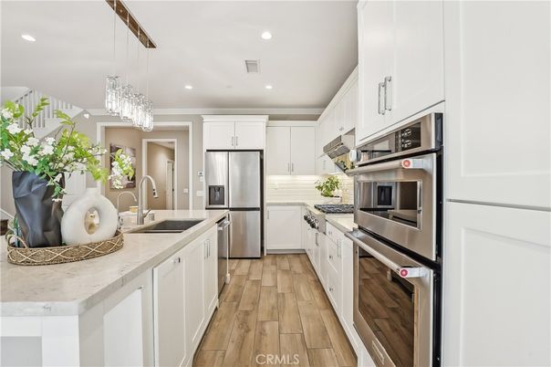 Chandelier, Interior, Kitchen, Pendant Lights, Recessed Lighting, Stainless Steel Appliances, Wood Texture Flooring